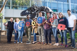 John Morada (left) and students hold up letters that spell out 'Google'.