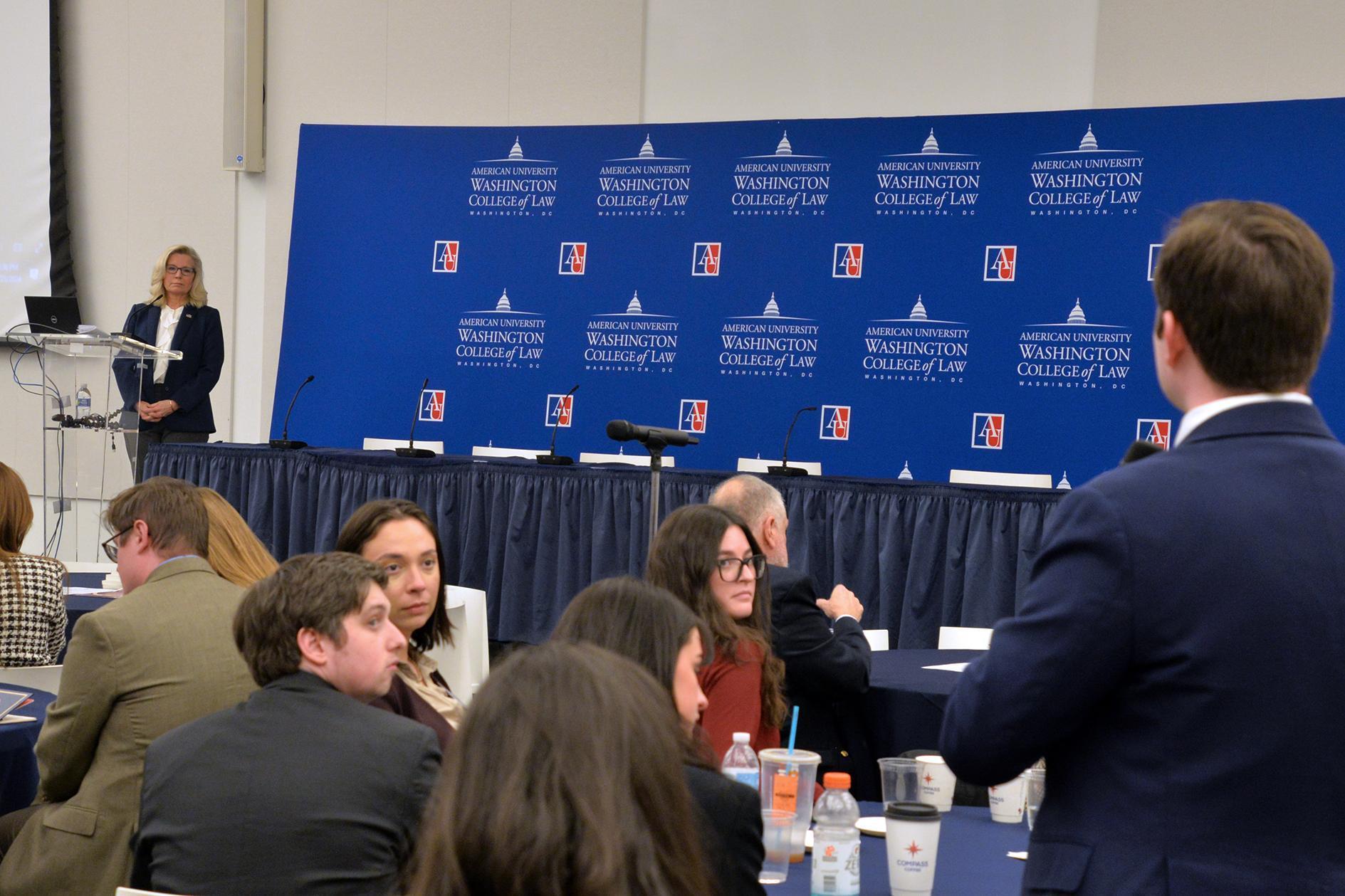 Former Representative Liz Cheney listens intently to one of several questions from the audience, this one from a student.