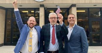 Ryan Durazo '21 (left), Henry Pachnowski (center), and Professor Jayesh Rathod (right) after Pachnowski was sworn in as a U.S. citizen.